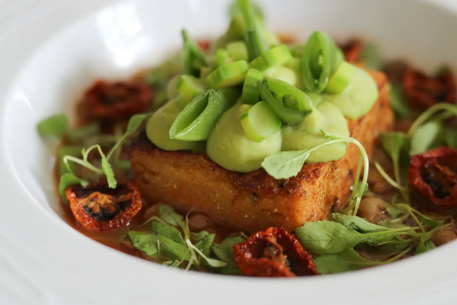 Polenta cake with peas and dried tomato