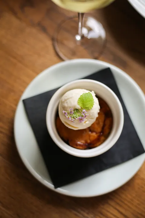 Gooseberry bake with vanilla ice cream in a small dish