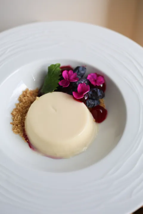 Spruce shoot panna cotta with honeyberries