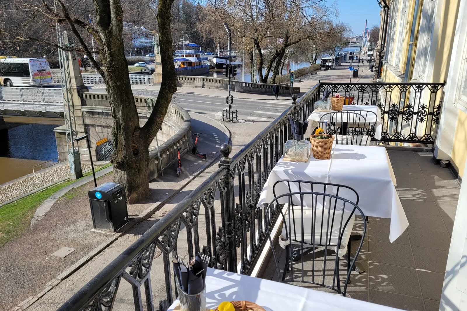 A laid table on the balcony facing the Aura river
